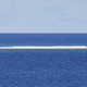 In this Friday, April 21, 2017 photo, a sandbar is seen from the Philippine-claimed Thitu Island off the disputed South China Sea in western Philippines. On Tuesday, Aug. 22, 2017, two Filipino security officials said China has deployed its navy and coast guard ships in a cluster of uninhabited sandbars in the disputed South China Sea amid concerns that the Philippines may build structures on them in an emerging territorial issue that the government stated was quickly resolved.